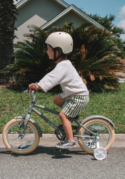 A boy riding Glerc Bikes with a white glerc helmet.